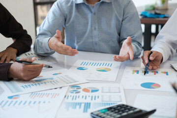 A team of business people is brainstorming to analyze investment project data.