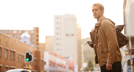 Travel, city and man in street with bag for walking, commute and journey in urban town. Fashion,...