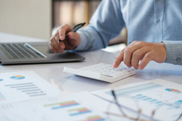 Accountants are using calculators to calculate budgets and investments.