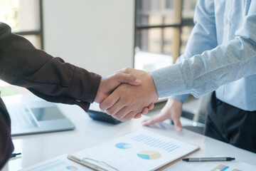 Businessmen shake hands after completing a business deal.