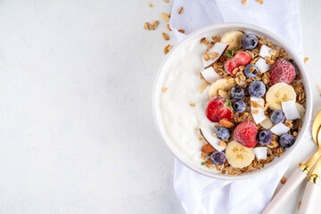 Breakfast yogurt granola bowl with fruit and berry