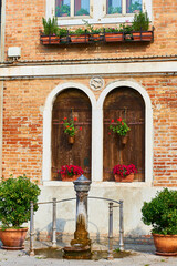 Fototapeta na wymiar Detail of architecture and Iron Fountain in Murano, Venice, Veneto, Italy.