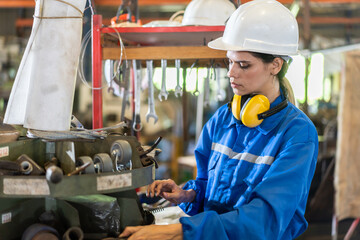 Industrial innovation with empowering of female engineer in factory setting, poised with tools of...