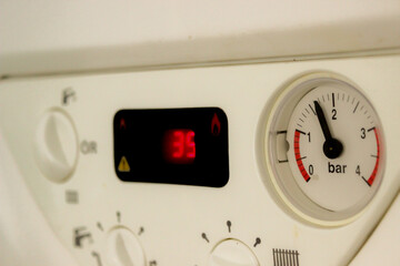 On off pause buttons and gauges on household devices close up view