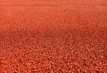 Red playground surface in perspective.