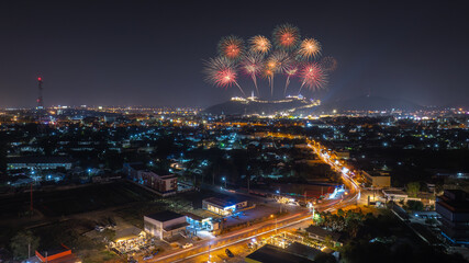 Fototapeta premium Firework over the mountain in the festival (Phra Nakhon Khiri) and city lights at night scene Phetchaburi province. Thailand.