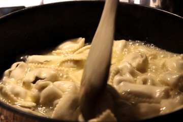 Ravioli preparationi in the pan close up view