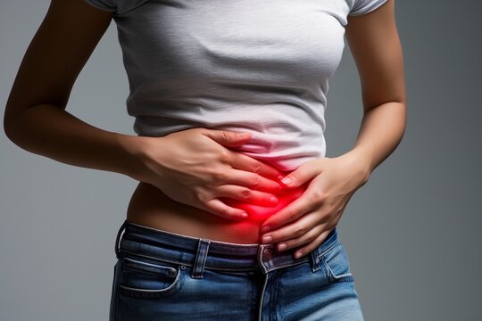 Girl holding her stomach in pain, suffering from stomach pain
