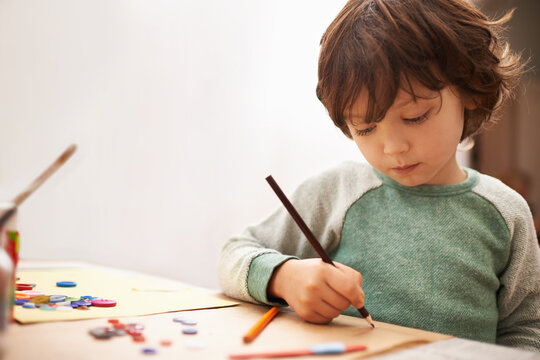 Little boy, drawing and writing with pencil for art, craft or color in learning creativity or education at home. Young child for sketching, artwork or creative imagination in childhood development