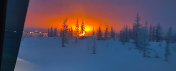 Night pillar of fire at an oil refinery village