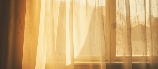 The amber rays of the sun are filtering through the goldtinted curtains of the window, casting a warm glow on the hardwood flooring