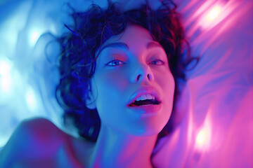 woman lying on bed having an orgasm while having sex in bedroom