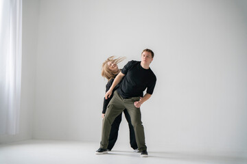 Contemporary Dance Duo of male and female Practicing an Intimate Routine in a Bright Studio