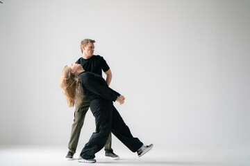 young male and female pair Practicing a Dynamic Routine, doing modern dance choreography