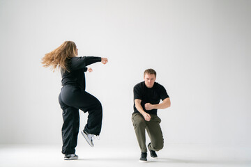 young male and female pair Practicing a Dynamic Routine, doing modern dance choreography - 762187211
