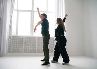 modern moves of routine in dance clip performing by young man and woman