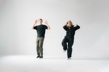 Contemporary Dance Duo Performing Routine Moves in a white Studio - 762187418
