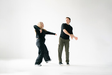 Contemporary Dance Duo Performing Routine Moves in a white Studio - 762187439