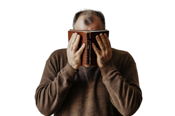 A depressed man covers his face with a book isolated on a transparency background
