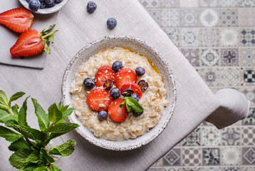 oatmeal porridge with strawberries blueberries and honey