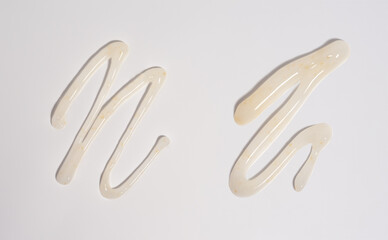 White smear of cosmetic cream isolated on white background. Creamy foundation texture isolated.