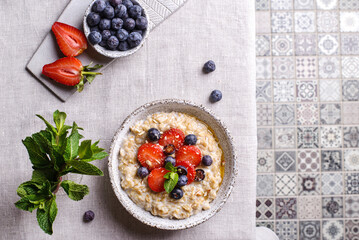 oatmeal porridge with strawberries blueberries and honey