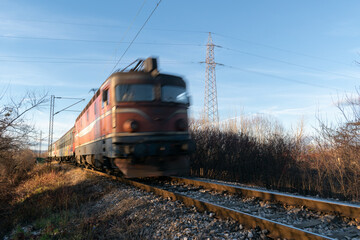 Train approaching with motion blur in Banja Luka countryside, railroad travel passenger train