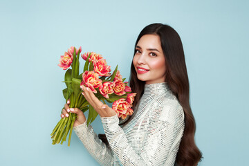 Happy beauty woman with pink tulip bouquet on blue background. 8th of March celebration - 762201030