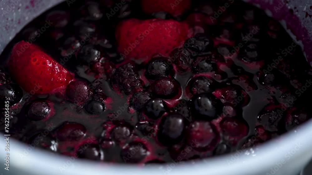 Canvas Prints Preparing mixed berry compote from frozen berries in a nonstick cooking pot.