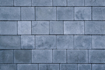 The sidewalk tiles are a light grey color and have a slightly rough texture for extra traction....