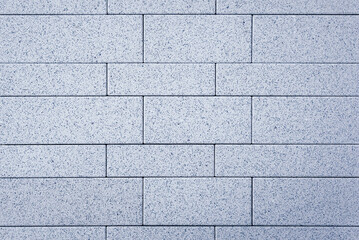 The new concrete sidewalk tiles have a smooth, grey surface with a subtle line pattern. background