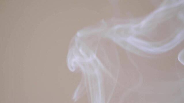Waves of smoke slowly rise up