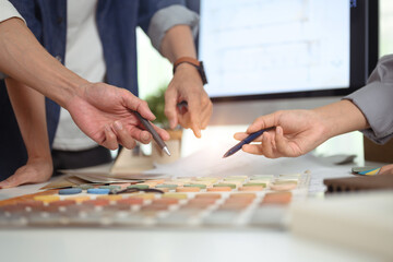 Interior designer team selecting colors for building at co working space in office