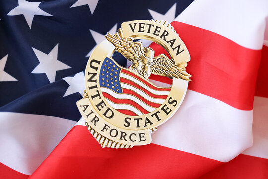 KYIV, UKRAINE - MARCH 9, 2024 US Air Force Veteran badge on United States of America flag close up