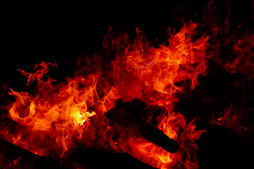 Fire burning on firewood in the dark