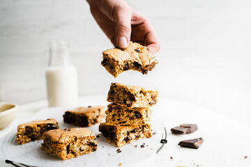 Hand holding homemade chocolate chip brownies