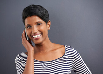 Woman, portrait and phone call with confidence of a creative employee with grey background ready...