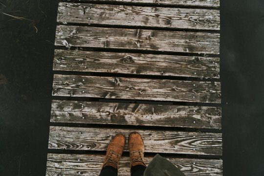 Hiking shoes standing on wooden pathway in outdoor environment