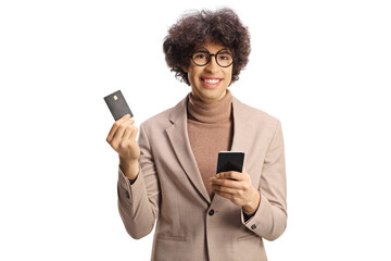 Happy young man holding a credit card and a smartphone
