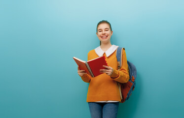 teenager on color paper wall background