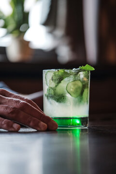 refreshing cucumber mint cocktail in square glass