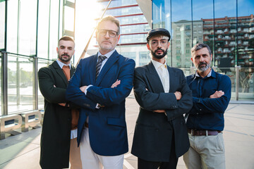 Portrait of a group of real businessmen looking at camera with serious and confident expression. Successful male coworkers staring front. Masculine professional people. Meeting of corporate partners
