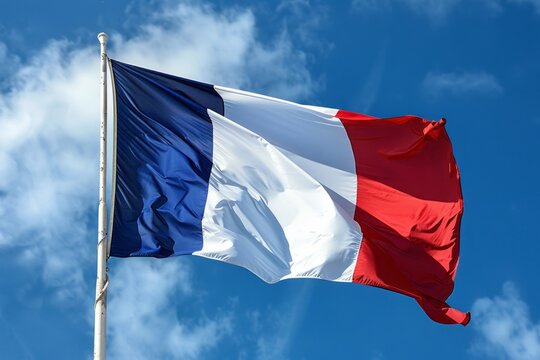 The French flag is fluttering in the wind against the clear blue sky