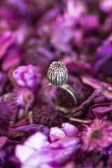 Beautiful silver ring with pink stone on a background of dry purple flowers. Handcraft precious item. - 762248088