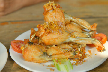 Fried frog topped with garlic sauce