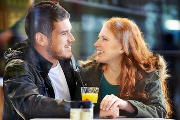 Look, happy and couple in restaurant for care on date for relationship anniversary with commitment, support and trust. Man, woman and in love together, hand holding and affection in cafe for bonding.