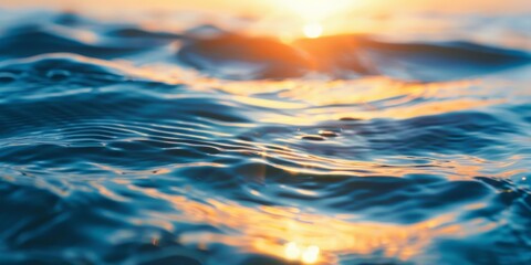 Obraz premium Sunset over calm ocean creating golden reflections on the water surface.