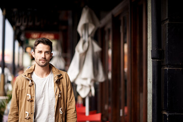 Man, face and serious in city with fashion on mockup space with urban style, trendy outfit or...