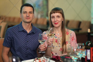 husband and wife (mr) with raised wine glasses on anniversary, feast