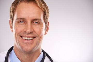 Man, doctor and portrait in studio, medical expert and specialist on gray background. Happy male...
